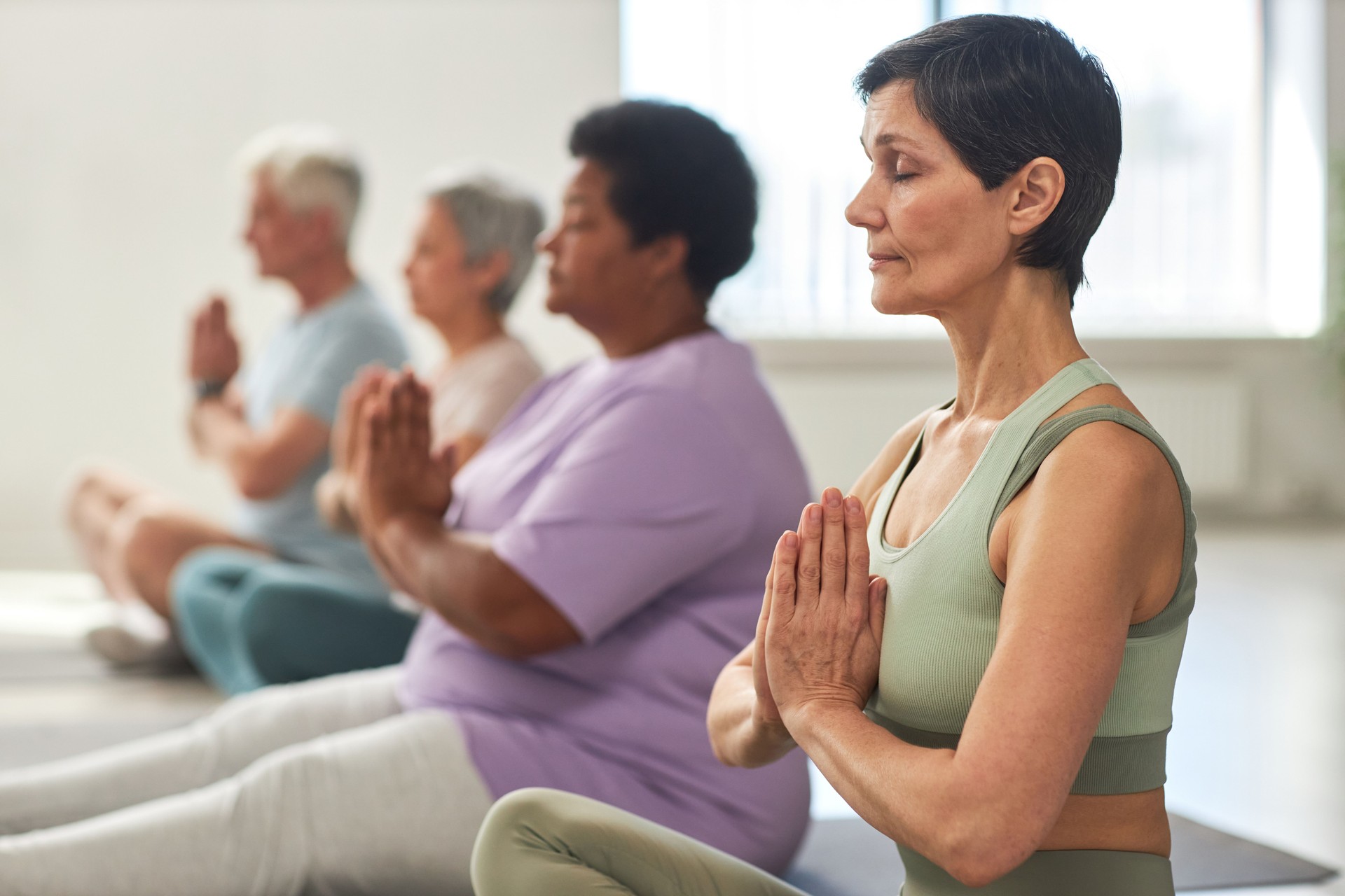 People meditating in yoga class